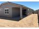 The backyard provides a patio with sliding door access to the home and low maintenance desert landscaping at 5526 S 246Th Ave, Buckeye, AZ 85326