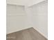 A spacious walk-in closet with ample shelving and carpeted floor at 5526 S 246Th Ave, Buckeye, AZ 85326