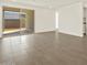 Bright living room with sliding glass doors and neutral-toned tile flooring at 5526 S 246Th Ave, Buckeye, AZ 85326