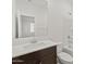 Bright bathroom featuring white walls, dark vanity, white countertop, and a tub at 5537 S 246Th Ave, Buckeye, AZ 85326