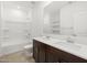 Well-lit bathroom showcasing dual sinks, dark vanity, a tub, and white countertops at 5537 S 246Th Ave, Buckeye, AZ 85326