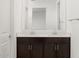 Close-up of the modern bathroom vanity featuring double sinks and a large mirror at 5537 S 246Th Ave, Buckeye, AZ 85326
