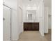 Bathroom with double sink vanity, wood-look flooring, and a walk-in shower at 5537 S 246Th Ave, Buckeye, AZ 85326