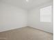 Sunlit bedroom featuring neutral carpet, white walls, and a bright window at 5537 S 246Th Ave, Buckeye, AZ 85326