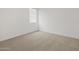 Well-lit bedroom with neutral carpet, white walls, and a window at 5537 S 246Th Ave, Buckeye, AZ 85326