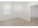 Bright bedroom featuring a window, light wood-look floors, and white walls at 5537 S 246Th Ave, Buckeye, AZ 85326