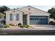 Charming single-story home featuring a two-car garage, desert landscaping, and stylish exterior paint at 5537 S 246Th Ave, Buckeye, AZ 85326