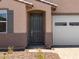 Inviting front entry with a stylish gray door and a convenient two-car garage at 5537 S 246Th Ave, Buckeye, AZ 85326
