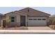 Charming single-story home with a gray door, two-car garage, and low-maintenance front yard at 5537 S 246Th Ave, Buckeye, AZ 85326