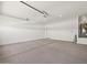 Clean two-car garage showcasing concrete flooring, door to the home, and water heater at 5537 S 246Th Ave, Buckeye, AZ 85326