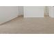 Hallway with neutral walls and wood-look tile flooring and multiple doors at 5537 S 246Th Ave, Buckeye, AZ 85326