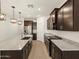 Spacious kitchen featuring granite countertops, stainless steel appliances, and dark wood cabinets at 5537 S 246Th Ave, Buckeye, AZ 85326