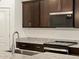Close-up of a kitchen with granite counters, dark cabinets, and stainless steel appliances at 5537 S 246Th Ave, Buckeye, AZ 85326