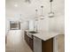 Modern kitchen boasts a large island with pendant lighting and stainless steel appliances at 5537 S 246Th Ave, Buckeye, AZ 85326