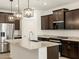 Modern kitchen featuring stainless steel appliances, granite countertops, and dark wood cabinets at 5537 S 246Th Ave, Buckeye, AZ 85326