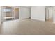Spacious living room with wood-look tile flooring and sliding doors to the backyard at 5537 S 246Th Ave, Buckeye, AZ 85326