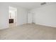 Bright and airy main bedroom featuring neutral carpet and a glimpse into the ensuite bathroom at 5537 S 246Th Ave, Buckeye, AZ 85326