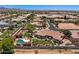 Home's backyard with lush landscaping, swimming pool, and relaxing patio area surrounded by desert scenery at 5755 S Pearl Dr, Chandler, AZ 85249