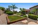 Green backyard with an elevated play area, shrubbery and palm trees at 5755 S Pearl Dr, Chandler, AZ 85249