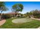 Well-manicured backyard featuring a putting green, tasteful shrubbery and patio at 5755 S Pearl Dr, Chandler, AZ 85249