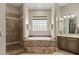 Luxurious bathroom featuring a soaker tub and separate tiled shower at 5755 S Pearl Dr, Chandler, AZ 85249