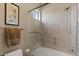 Bathroom featuring a glass shower and tub combination with neutral tiling, fixtures and hardware at 5755 S Pearl Dr, Chandler, AZ 85249