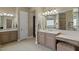 Elegant bathroom featuring double vanities, stone countertops, and tiled floors at 5755 S Pearl Dr, Chandler, AZ 85249