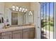 Bathroom featuring a countertop sink with decorative tiling and an exterior door for outside light and ventilation at 5755 S Pearl Dr, Chandler, AZ 85249