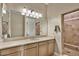 This bathroom boasts a spacious vanity with a sink and a large mirror with decorative lighting at 5755 S Pearl Dr, Chandler, AZ 85249