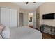 Comfortable bedroom featuring wood floors, closet space, and access to the bathroom at 5755 S Pearl Dr, Chandler, AZ 85249