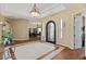Large foyer featuring tray ceiling, hardwood floors, custom lighting, and arched doorways at 5755 S Pearl Dr, Chandler, AZ 85249