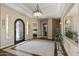 Spacious foyer featuring tray ceilings, decorative lighting, and wrought iron front door at 5755 S Pearl Dr, Chandler, AZ 85249