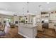 Bright kitchen boasts stainless appliances, a center island, and stunning stone countertops at 5755 S Pearl Dr, Chandler, AZ 85249