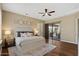 Bright main bedroom featuring wood floors, a ceiling fan, and a sliding door at 5755 S Pearl Dr, Chandler, AZ 85249