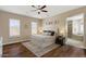 Spacious main bedroom featuring a ceiling fan, natural light, and wood floors at 5755 S Pearl Dr, Chandler, AZ 85249