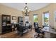 Spacious home office features built-in shelving, hardwood floors, and natural lighting at 5755 S Pearl Dr, Chandler, AZ 85249
