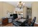 Bright office with built-in shelving, sleek desk, and an elegant chandelier at 5755 S Pearl Dr, Chandler, AZ 85249