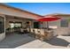 Outdoor kitchen with a red umbrella, grill, sink, and barstool seating at 5755 S Pearl Dr, Chandler, AZ 85249
