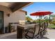 Covered outdoor kitchen features a built-in grill and barstool seating at 5755 S Pearl Dr, Chandler, AZ 85249