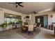 A covered patio with ceiling fans, a table with chairs, and outdoor kitchen at 5755 S Pearl Dr, Chandler, AZ 85249