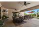 Spacious covered patio with a ceiling fan, outdoor kitchen, and seating at 5755 S Pearl Dr, Chandler, AZ 85249