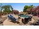 Relaxing pool area with a rock waterfall, lounge chairs, and a fire pit at 5755 S Pearl Dr, Chandler, AZ 85249