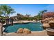 Backyard pool features a rock waterfall, and an array of lounge seating at 5755 S Pearl Dr, Chandler, AZ 85249