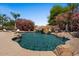 Backyard pool features a rock waterfall, a slide and a basketball hoop at 5755 S Pearl Dr, Chandler, AZ 85249