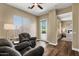 Comfortable sitting room with two oversized chairs, a ceiling fan, and natural light at 5755 S Pearl Dr, Chandler, AZ 85249