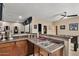 Wet bar with a stone countertop, wooden cabinets and stainless steel sink adjoining the game room at 5755 S Pearl Dr, Chandler, AZ 85249