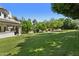 Expansive backyard with lush lawn, mature trees, a built-in outdoor grill, and a charming pool at 6467 E Sierra Vista Dr, Paradise Valley, AZ 85253