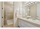 Bright bathroom with dual sinks, white cabinets, and a glass-enclosed shower with a towel warmer at 6467 E Sierra Vista Dr, Paradise Valley, AZ 85253