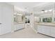 Bright primary bathroom with dual sinks, white cabinets and bright neutral walls and floors at 6467 E Sierra Vista Dr, Paradise Valley, AZ 85253