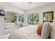 Bright bedroom features a large window, a mirrored closet, and a comfortable bed with decorative pillows at 6467 E Sierra Vista Dr, Paradise Valley, AZ 85253